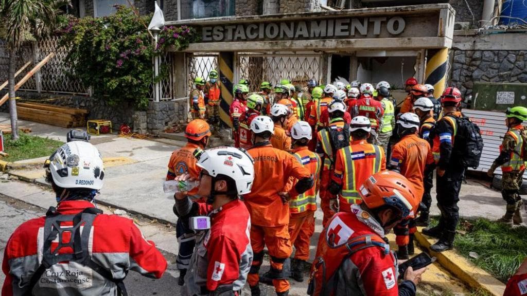 Rescuers inch closer to quake survivor after eight days - and he's cheering them on