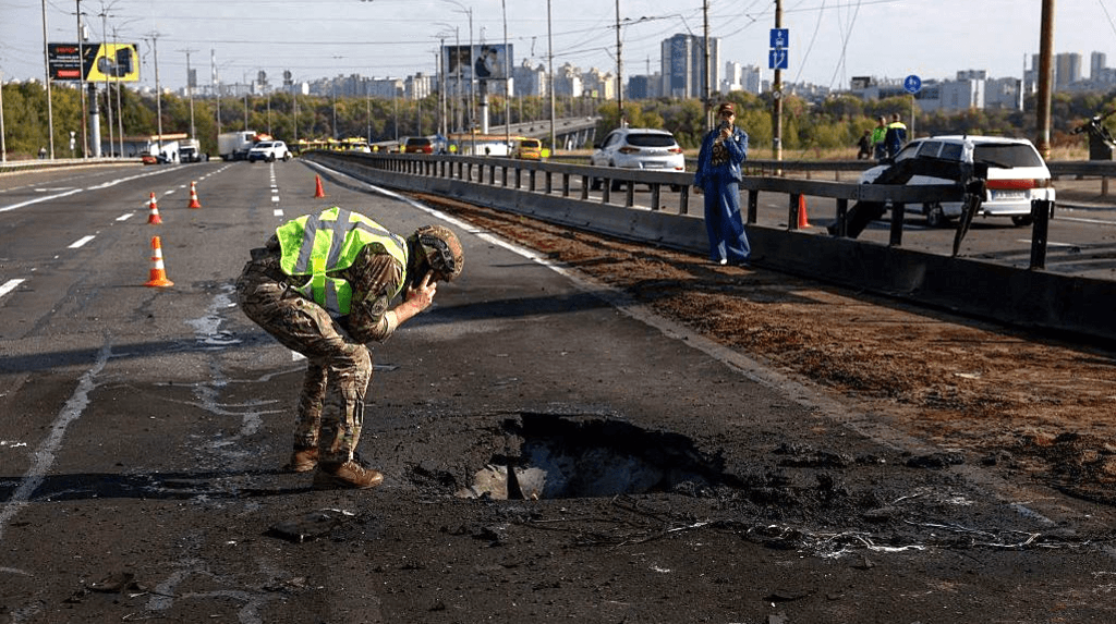 Kyiv bridge hit in further Russian drone attack as German chancellor makes surprise visit