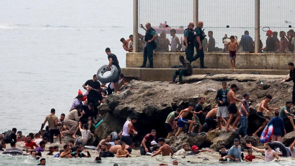 Hundreds of migrants swim from Morocco to Spanish enclave of Ceuta