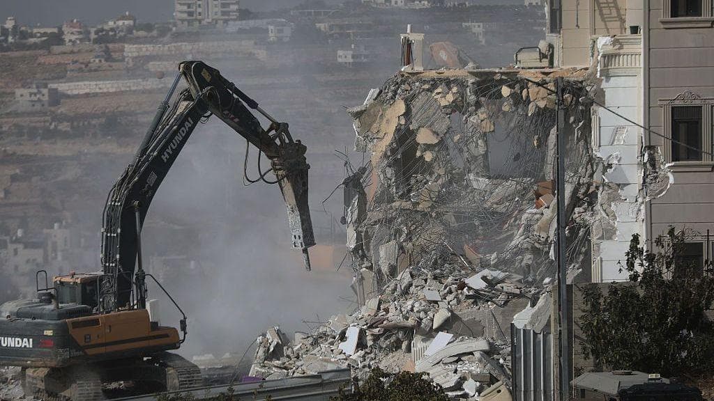 Israeli forces begin demolishing Palestinian buildings in Hebron after two Israeli soldiers shot dead