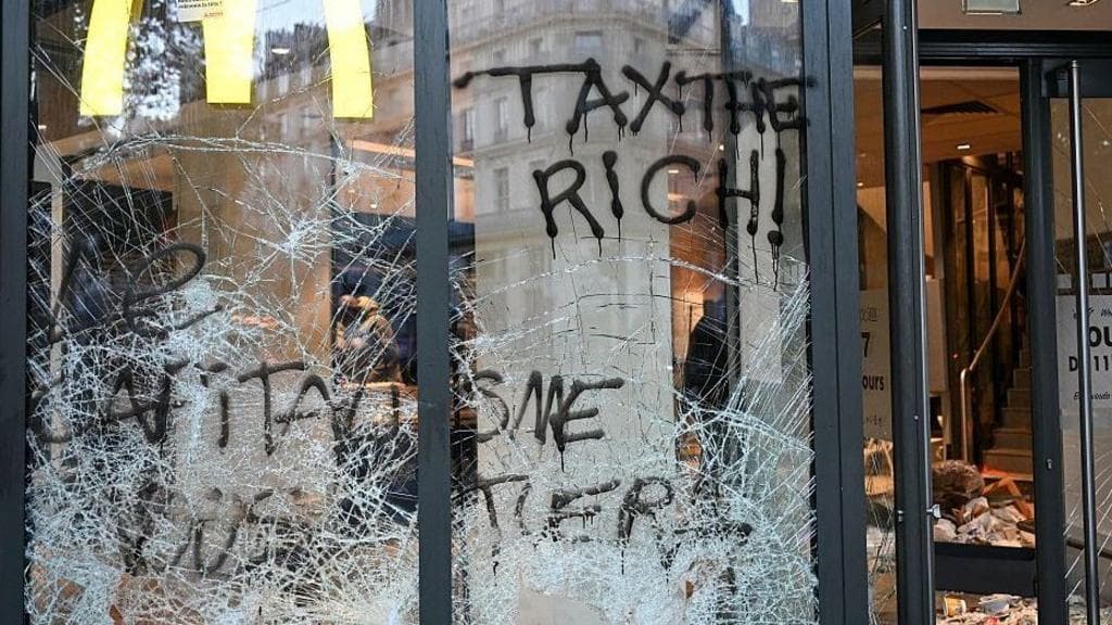 Burnt out cars and shattered glass on Paris streets after protests turn to riots and looting